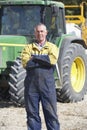 Driver Standing In Front Of Tractor