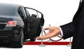 Driver standing with welcome gesture next to limousine Royalty Free Stock Photo