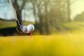 Driver with teed golf ball on course