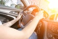 Driver training car on road in summer sunny day. Happy young woman inside vehicle driving. Vacation ride trip travel concept