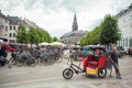 A driver of tricycle rickshaw waits for customers in Copenhagen