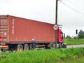 The driver of the truck repairs the headlight after the accident. Kuvshinovo, Tver region.