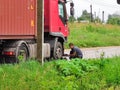 The driver of the truck repairs the headlight after the accident. Kuvshinovo, Tver region.
