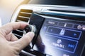 Driver turning volume button of car radio Royalty Free Stock Photo