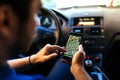 Young driver using gps navigation system, online maps and smartphone for guidance Royalty Free Stock Photo