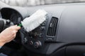 Driver using soft microfiber cleaning brush duster cleaner on car dashboard Royalty Free Stock Photo
