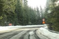 Driver view on sharp road curve, partially covered with snow in Royalty Free Stock Photo