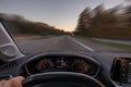 Driver view to the cars speedometer and the road blurred in motion