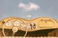 Driver view of a vintage classic open cabriolet car in front of a sunny blue sky