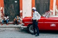 A driver waits for his clients by his classic car in Havana, Cuba. Royalty Free Stock Photo