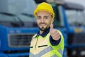 driver wearing reflective jacket holding thumbs up Royalty Free Stock Photo