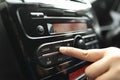 Driver& x27;s Hand Press Button on Car Radio Royalty Free Stock Photo