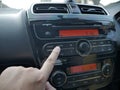 Driver& x27;s Hand Press Button on Car Radio Royalty Free Stock Photo