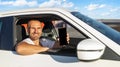 The driver is a young attractive man driving a car. Royalty Free Stock Photo