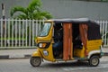 Drivers of yellow tuk tuks ply their trade around the port city