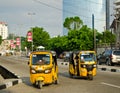 Drivers of yellow tuk tuks ply their trade around the port city