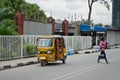 Drivers of yellow tuk tuks ply their trade around the port city