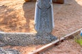 In a driveway near home concrete mixer truck pours ready-mixed cement concrete for driveway using wet cement Royalty Free Stock Photo