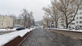 The driveway of the street, where cars are parked, is paved with treated stone and the sidewalks with concrete tiles. Along the ed Royalty Free Stock Photo