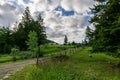 Driveway to the farm with welcome sign tree lined country road Royalty Free Stock Photo