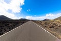 Driveway to Timanfaya National Park on the island of Lanzarote against blue sky. Canary Islands, volcanic area.