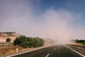 Driving along a road into a dust cloud Royalty Free Stock Photo