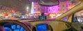 Driving along city traffic at night, view from car interior Royalty Free Stock Photo
