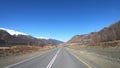 Driving along mountain asphalt road Chuysky Tract along Kurai Ridge on Altai betveen Kosh-Agach and Kurai intermountain hollows