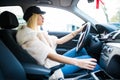 Young attractive woman smiling and looking straight while driving a car Royalty Free Stock Photo