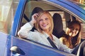 Driving around town. two young women traveling in a car in the city. Royalty Free Stock Photo