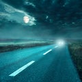 Driving on asphalt road at night towards the headlights Royalty Free Stock Photo