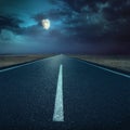 Driving on asphalt road at night towards the moon Royalty Free Stock Photo