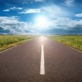 Driving on asphalt road towards the sun Royalty Free Stock Photo