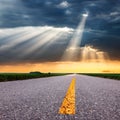Driving on asphalt road towards the sunbeams Royalty Free Stock Photo