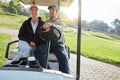 Driving back to the clubhouse. a young couple riding on a cart while enjoying a day on the golf course. Royalty Free Stock Photo