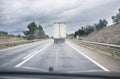 Driving behind slow truck on local road a rainy day