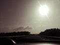 Driving with big sun in the sky