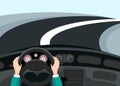 Driving car concept - hands on steering wheel with curved asphalt road