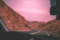 Driving a car on a desert mountain road Royalty Free Stock Photo