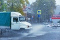 Driving car on flooded road during flood caused by torrential rains