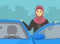 Driving a car. Happy muslim female driver leaning on the car door. Arab woman driver front close-up view.