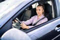 Driving car. Happy woman. Female taxi cab driver. Vehicle rent or sale business, dealership, chauffeur or rideshare service. Royalty Free Stock Photo