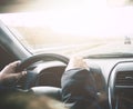 Driving car on a highway. Inside view of woman driver. Hands