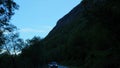 Driving in a car in mountains and forest in Norway with point of view through front windshield. Time lapse on road to Trollstigen