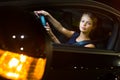 Pretty, young woman driving her modern car at night Royalty Free Stock Photo