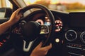 Driving a car at night - pretty, young woman driving her modern car at night in a city shallow DOF color toned image. Royalty Free Stock Photo