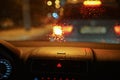 Driving car in the rain at night. Rainy weather view through the windshield with raindrops. Dash cap close up Royalty Free Stock Photo