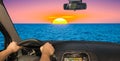 Driving a car towards a beautiful sunset by the sea, Italy Royalty Free Stock Photo