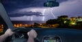 Driving a car towards a lightning storm over the sea