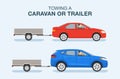 Driving a car. Towing a caravan or trailer. Side view of a red sedan and blue suv car on a city road. Royalty Free Stock Photo